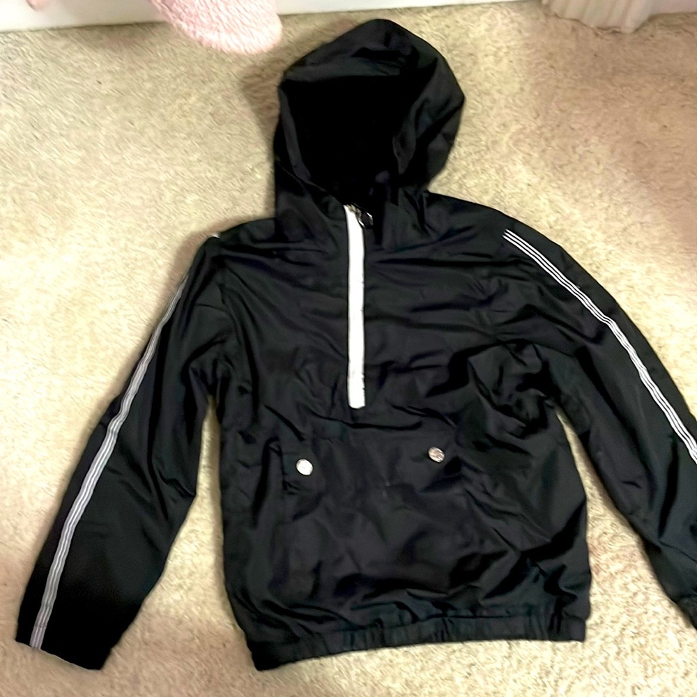 A black jacket with white stripes and a white zipper